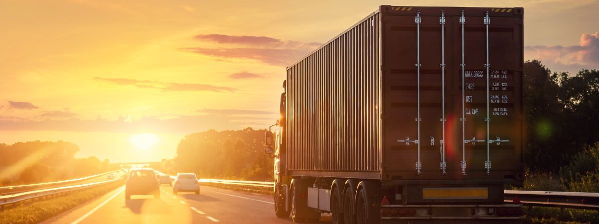 Trucker driving towards a sunset